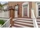 Home featuring brick front entrance, white banisters, and mahogany stained deck at 9221 Calabria Dr # 116, Raleigh, NC 27617