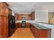 Spacious kitchen featuring wood cabinetry, stainless steel appliances and a breakfast bar at 9221 Calabria Dr # 116, Raleigh, NC 27617