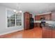 Bright kitchen featuring hardwood floors, granite countertops, and dark cabinets at 9221 Calabria Dr # 116, Raleigh, NC 27617