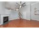 Bright living room boasts a fireplace, ceiling fan, and beautiful hardwood floors at 9221 Calabria Dr # 116, Raleigh, NC 27617