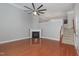 Bright living room boasts a fireplace, ceiling fan, and beautiful hardwood floors at 9221 Calabria Dr # 116, Raleigh, NC 27617