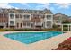 Community pool with lane markers, surrounded by manicured landscaping and townhome buildings at 9221 Calabria Dr # 116, Raleigh, NC 27617