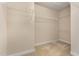 Spacious walk-in closet featuring carpet and multiple wire racks for ample storage at 9221 Calabria Dr # 116, Raleigh, NC 27617
