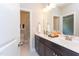 Bright bathroom with double sinks, a large mirror, and a shower-tub combination at 9517 Wood River Dr, Zebulon, NC 27597