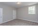 Inviting bedroom with neutral paint, carpet, and a window for natural light at 9521 Woodriver Dr, Zebulon, NC 27597