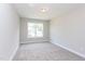 Bright bedroom with neutral walls, plush carpet, and a large window at 9517 Wood River Dr, Zebulon, NC 27597