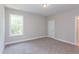 Comfortable bedroom with neutral walls, carpet, and a view to the outside at 9517 Wood River Dr, Zebulon, NC 27597