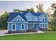 Beautiful two-story home featuring light blue siding and a meticulously manicured front yard at 9517 Wood River Dr, Zebulon, NC 27597