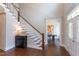 Inviting foyer with hardwood floors, staircase, and sight lines to the office and other areas at 9517 Wood River Dr, Zebulon, NC 27597