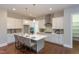 Modern kitchen featuring white cabinets, stainless steel appliances, and a spacious island with seating at 9517 Wood River Dr, Zebulon, NC 27597