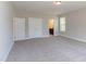 Large main bedroom with neutral tones, plush carpeting, and an attached bathroom at 9517 Wood River Dr, Zebulon, NC 27597