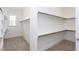 Spacious walk-in closet featuring built-in shelving and ample storage space at 9517 Wood River Dr, Zebulon, NC 27597