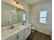 A bathroom with a double vanity, toilet and window at 100 N Stonemill Trl # Homesite 252, Wilson's Mills, NC 27520