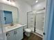 Bathroom with white vanity, framed mirror and a glass-enclosed shower at 100 N Stonemill Trl # Homesite 252, Wilson's Mills, NC 27520