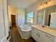 A bathroom with a tub, vanity, and a large window at 100 N Stonemill Trl # Homesite 252, Wilson's Mills, NC 27520