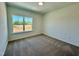 A carpeted bedroom with white walls has one window that lets in natural light at 100 N Stonemill Trl # Homesite 252, Wilson's Mills, NC 27520