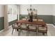 A spacious dining room featuring a large wooden table, comfortable chairs, modern lighting and large window at 100 N Stonemill Trl # Homesite 252, Wilson's Mills, NC 27520