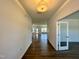 Bright hallway with wood floors leads to an open-concept living area with lots of natural light at 100 N Stonemill Trl # Homesite 252, Wilson's Mills, NC 27520