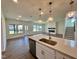 Open-concept kitchen with island sink, stainless appliances and living room view with fireplace at 100 N Stonemill Trl # Homesite 252, Wilson's Mills, NC 27520
