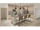 Modern kitchen with an island, pendant lighting, stainless steel appliances, and tile backsplash at 100 N Stonemill Trl # Homesite 252, Wilson's Mills, NC 27520