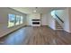 Spacious living room with large windows, a modern fireplace, and stairway access at 100 N Stonemill Trl # Homesite 252, Wilson's Mills, NC 27520