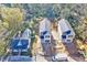 Aerial view of two gray two-story homes with black roofs amid a tree-lined neighborhood at 102 Woodson St, Oxford, NC 27565