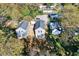 Aerial view of two gray two-story homes with black roofs amid a tree-lined neighborhood at 102 Woodson St, Oxford, NC 27565