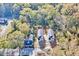 Aerial view of two gray two-story homes with black roofs amid a tree-lined neighborhood at 102 Woodson St, Oxford, NC 27565