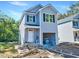 New two-story home featuring gray siding, black shutters, and a covered porch at 102 Woodson St, Oxford, NC 27565