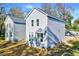 Newly built two-story home with gray siding and modern windows against a grassy background at 102 Woodson St, Oxford, NC 27565