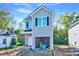 New two-story home featuring gray siding, black shutters, and an attached garage at 102 Woodson St, Oxford, NC 27565