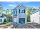 New two-story home showcasing gray siding, black shutters, and an attached garage at 102 Woodson St, Oxford, NC 27565