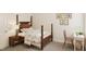 A charming bedroom features a classic four-poster bed, a cozy desk area, and whimsical decor at 104 N Stonemill Trl # Homesite 253, Clayton, NC 27520