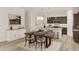 Dining room with wooden table set for a meal with views to the kitchen at 104 N Stonemill Trl # Homesite 253, Clayton, NC 27520