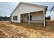 Exterior view of a home with a covered porch, showcasing its architectural design and backyard at 104 N Stonemill Trl # Homesite 253, Clayton, NC 27520