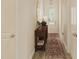 Elegant hallway featuring a console table, decorative mirror, and a patterned rug creating a welcoming entrance at 104 N Stonemill Trl # Homesite 253, Clayton, NC 27520
