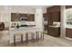 Modern kitchen with stainless steel appliances, a marble countertop island, and dark wood cabinetry at 104 N Stonemill Trl # Homesite 253, Clayton, NC 27520