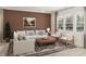 Cozy living room with plush seating, large windows, and a patterned rug, creating a warm and inviting atmosphere at 104 N Stonemill Trl # Homesite 253, Clayton, NC 27520