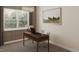 A home office featuring a desk, chair, decorative chandelier, and a large window overlooking the outdoors at 104 N Stonemill Trl # Homesite 253, Clayton, NC 27520