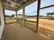 Covered porch with wooden railings overlooks the construction site, seamlessly blending indoor and outdoor living at 104 N Stonemill Trl # Homesite 253, Clayton, NC 27520