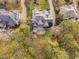 Aerial view of the property, highlighting the backyard deck and patio that is surrounded by mature trees at 105 Links End Dr, Cary, NC 27513