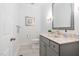 Bathroom features a modern vanity with stone countertop, updated fixtures, and framed mirror at 105 Links End Dr, Cary, NC 27513