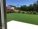 View of an expansive lawn extending from a new home's patio, backed by lush foliage at 1404 Malcus Ct # 56, Fuquay Varina, NC 27526