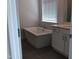 Bathroom featuring a soaking tub, and vanity with stone countertop at 1404 Malcus Ct # 56, Fuquay Varina, NC 27526