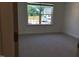 Bedroom with carpet floors and window overlooking construction and trees at 1404 Malcus Ct # 56, Fuquay Varina, NC 27526