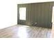 Bedroom with modern, dark green wainscoting and a light hardwood floor at 1404 Malcus Ct # 56, Fuquay Varina, NC 27526