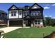 Beautiful new construction home with a two-car garage and manicured lawn at 1404 Malcus Ct # 56, Fuquay Varina, NC 27526