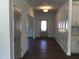 Bright hallway featuring fresh paint, hardwood floors and decorative trim at 1404 Malcus Ct # 56, Fuquay Varina, NC 27526