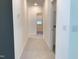 Hallway with carpet flooring leading to a sunlit room with a window at 1404 Malcus Ct # 56, Fuquay Varina, NC 27526