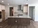 Bright kitchen features an island with stone countertops, a modern oven, and white cabinets for storage at 1404 Malcus Ct # 56, Fuquay Varina, NC 27526